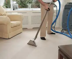 Carpet cleaning professional removing dirt and stains with a hot-water extraction tool in a home, Allentown, PA.